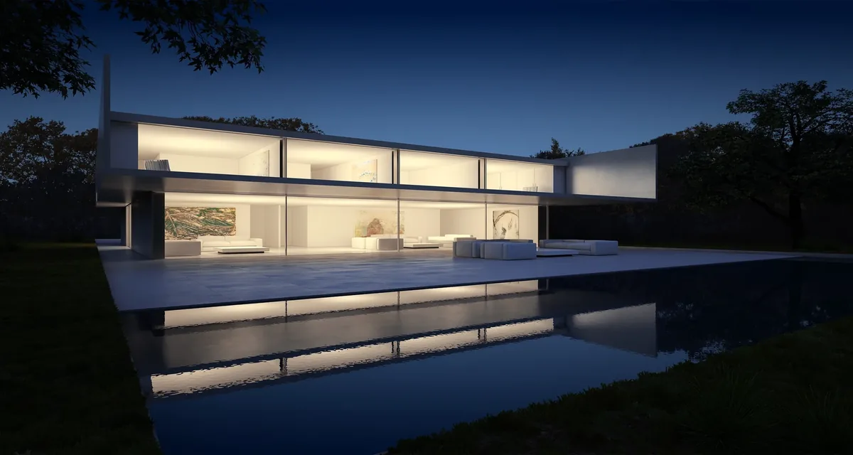 Contemporary luxury home illuminated beside a reflecting pool